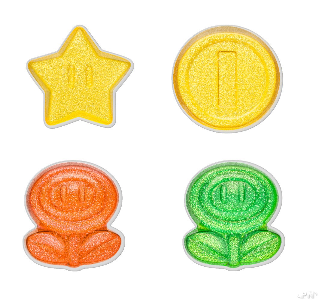 les 4 items de la gamme en édition limitée de bonbons Haribo P!k x Super Mario : étoile, fleurs de feu au goût pomme ou fraise, et pièce d'or